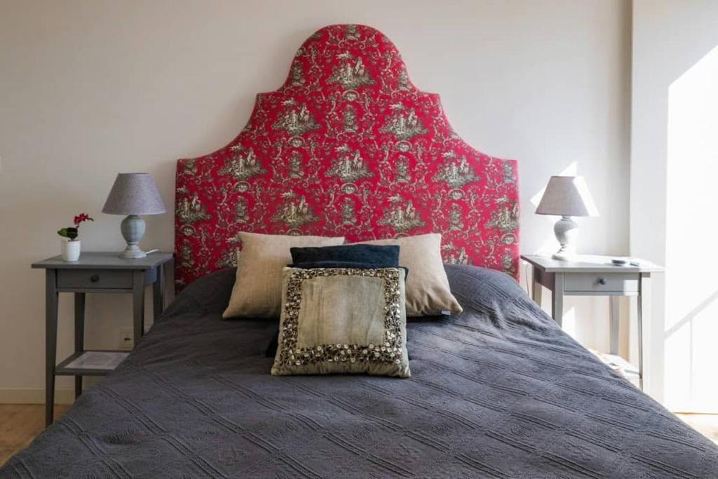 a bedroom with a large bed with a red headboard at Tings Lisbon in Lisbon