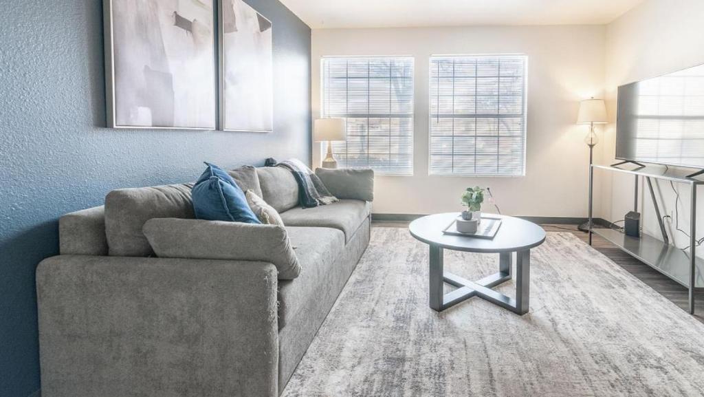 a living room with a couch and a table at Landing - Modern Apartment with Amazing Amenities (ID7250X84) in Albuquerque