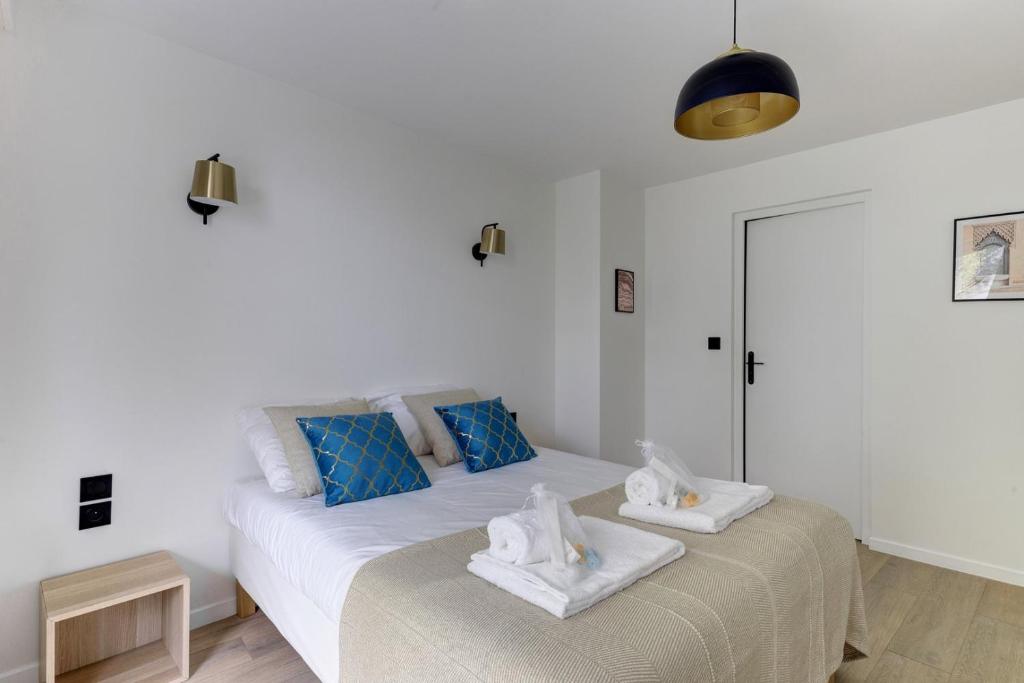 a bedroom with two beds with towels on them at 322 Suite Fes - Superb apartment in Suresnes