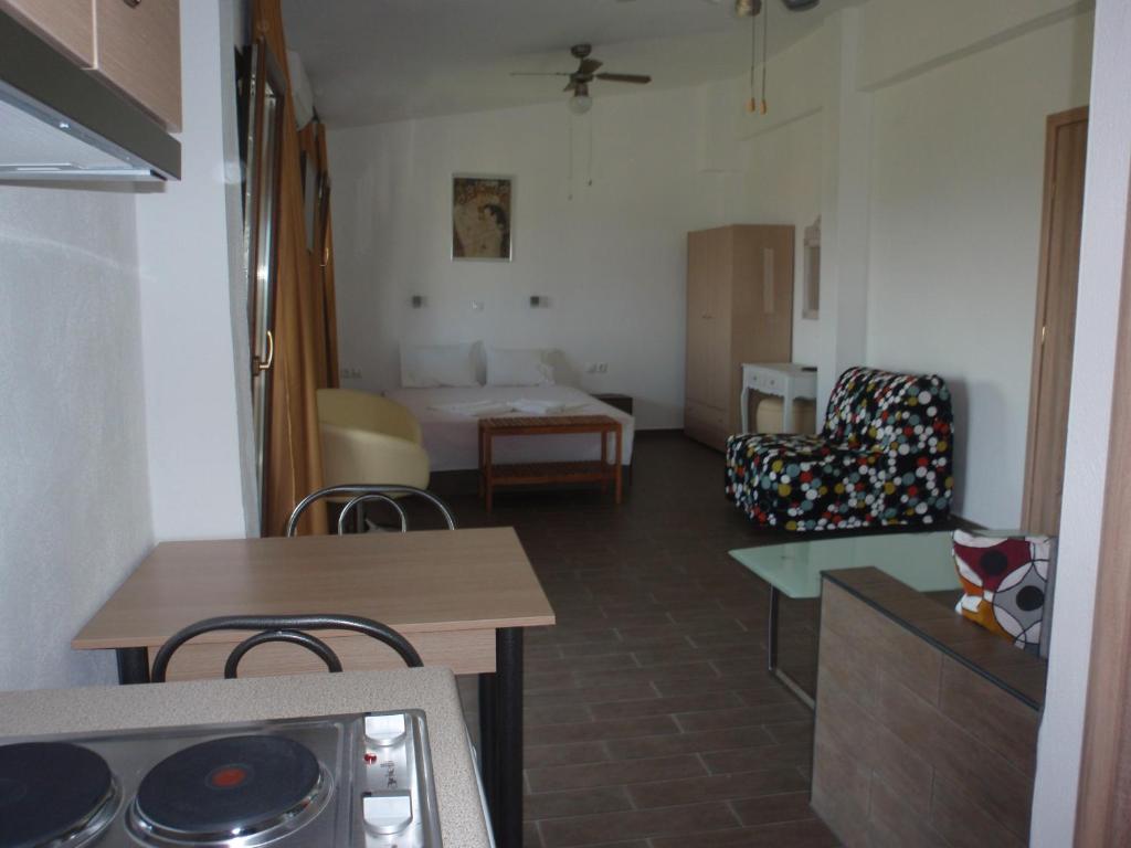 a room with a kitchen and a living room at Petrouda's Apartments in Samothráki