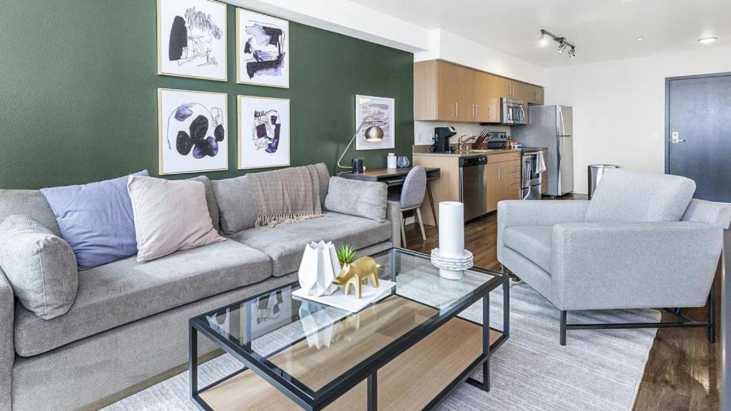 a living room with a couch and a table at Landing Modern Apartment with Amazing Amenities (ID8925X56) in Tacoma