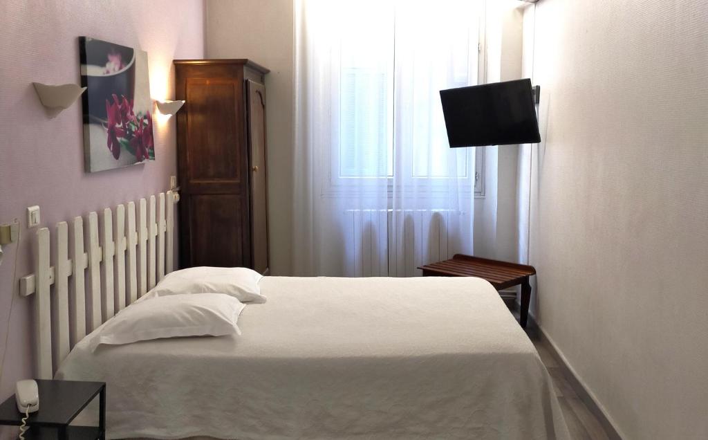 Postel nebo postele na pokoji v ubytování Au Nouvel Hôtel