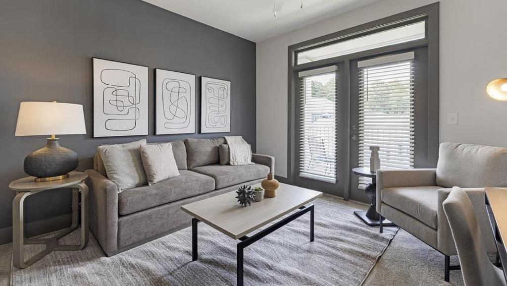 a living room with a couch and a table at Landing - Modern Apartment with Amazing Amenities (ID9684X38) in Flowery Branch
