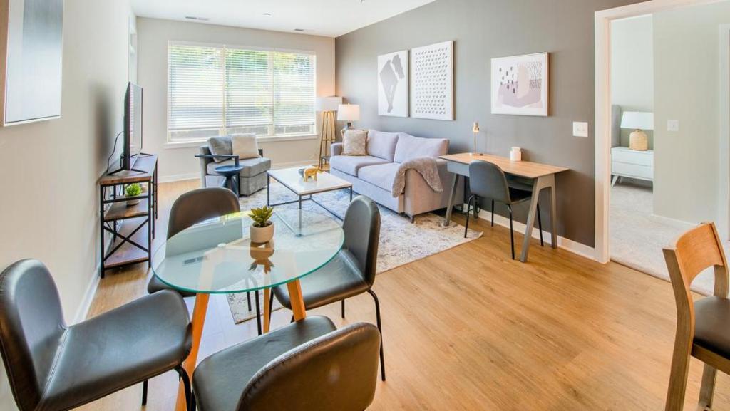 Landing - Modern Apartment with Amazing Amenities (ID4177X58) في أوينغز ميلز: غرفة معيشة مع أريكة وطاولة