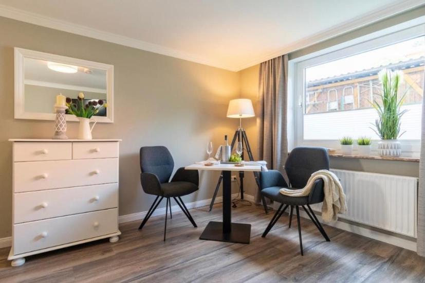 a room with a table and chairs and a window at Haus Schwanensee, Wohnung 9 in Bosau