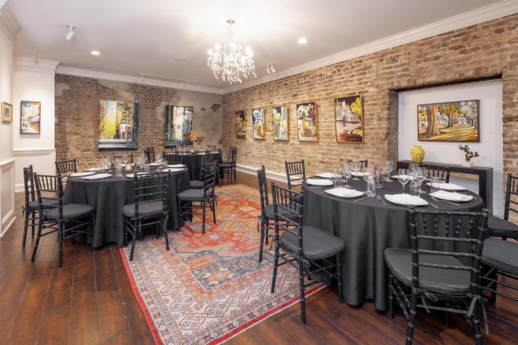 a room with long tables and chairs in it at The Vendue, Downtown Art Hotel in Charleston