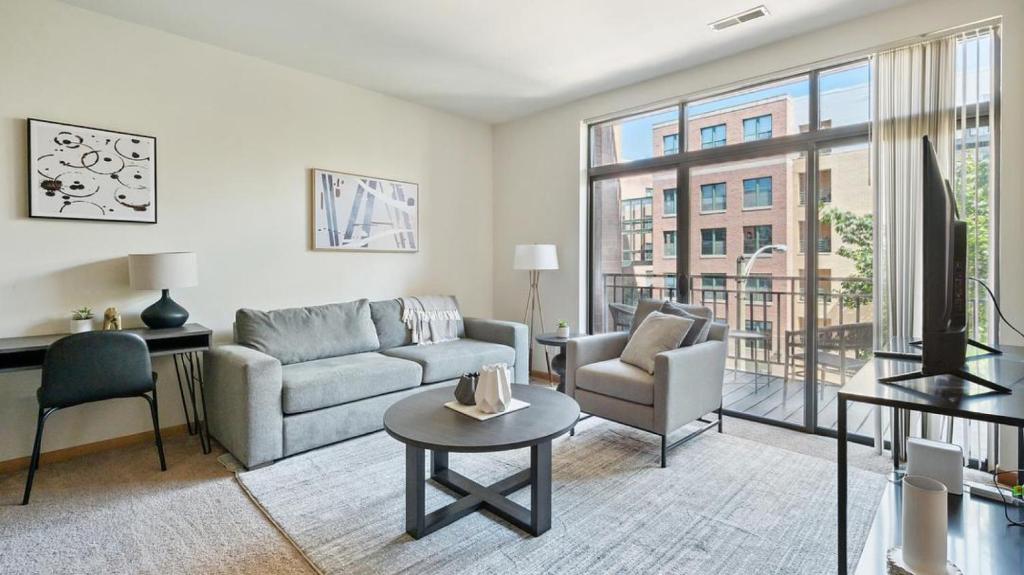 a living room with a couch and a table at Landing - Modern Apartment with Amazing Amenities (ID9415X89) in Milwaukee