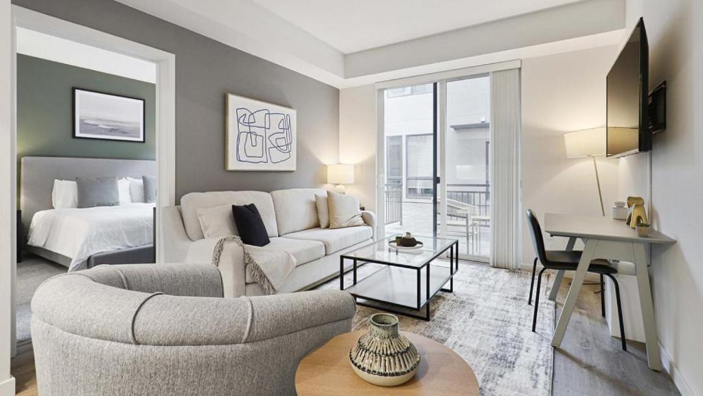 a living room with a white couch and a bed at Landing - Modern Apartment with Amazing Amenities (ID7668X57) in Oakland