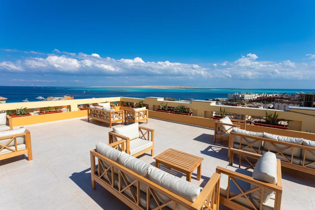 a patio with chairs and tables on top of a building at Lazur Hotel Apartments in Hurghada