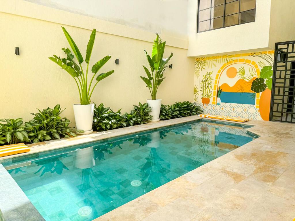 a swimming pool in a house with plants at Hotel Valladolid in Santa Marta