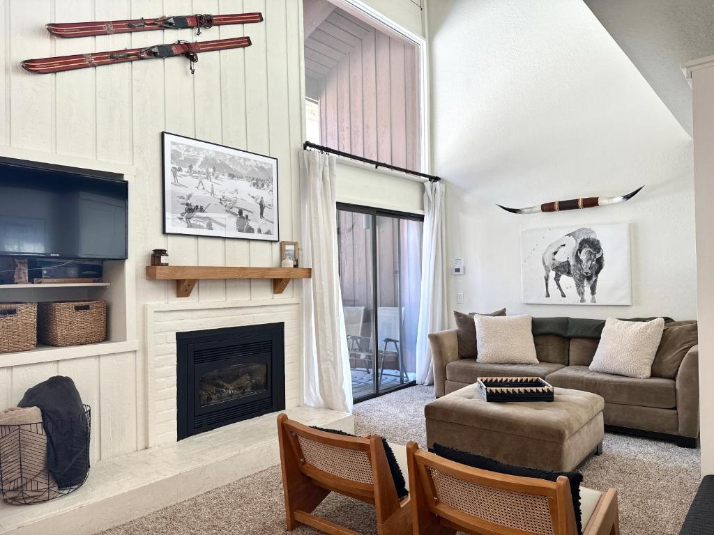 a living room with a couch and a fireplace at Epic Condo walk to Canyon Lodge in Mammoth Lakes