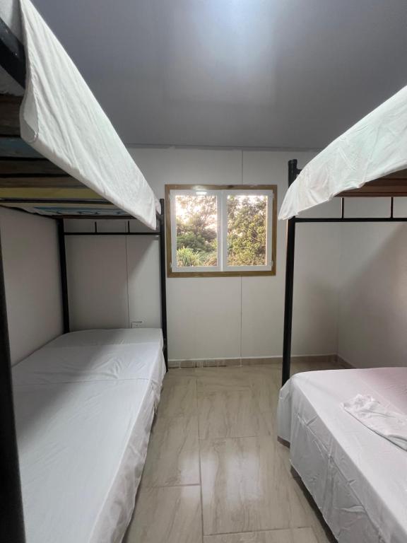 Postel nebo postele na pokoji v ubytování JAZMIN HOsTEL