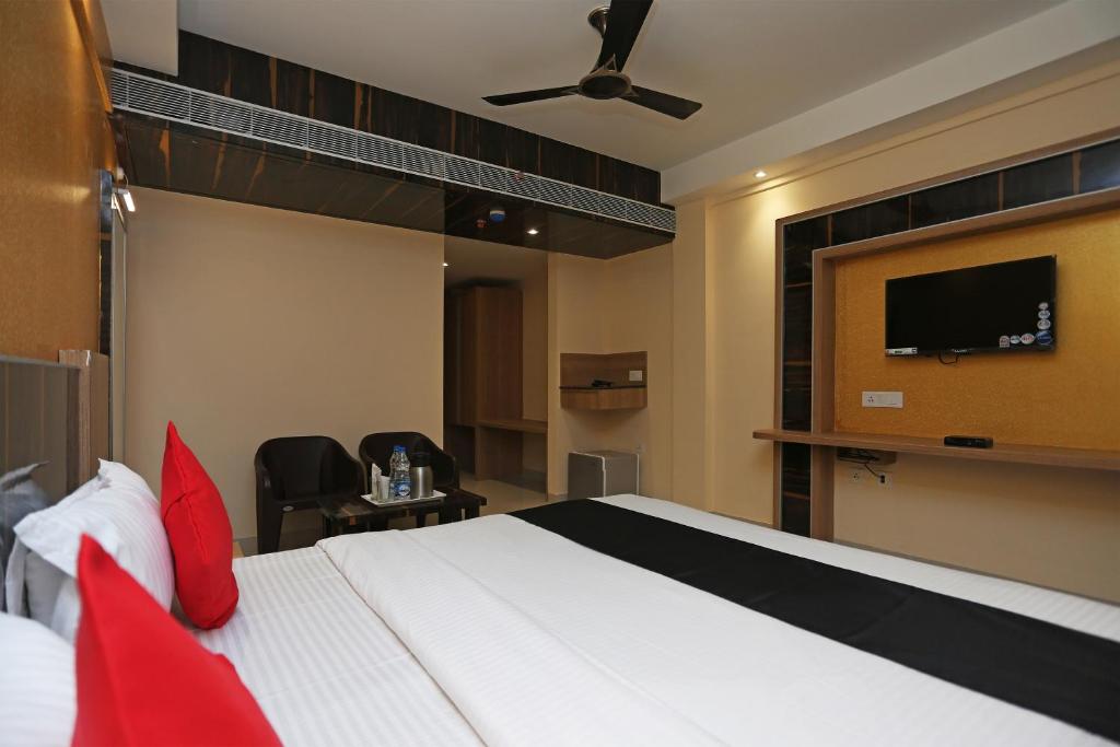 a bedroom with a bed and a flat screen tv at Hotel Victoria Royal in Puri