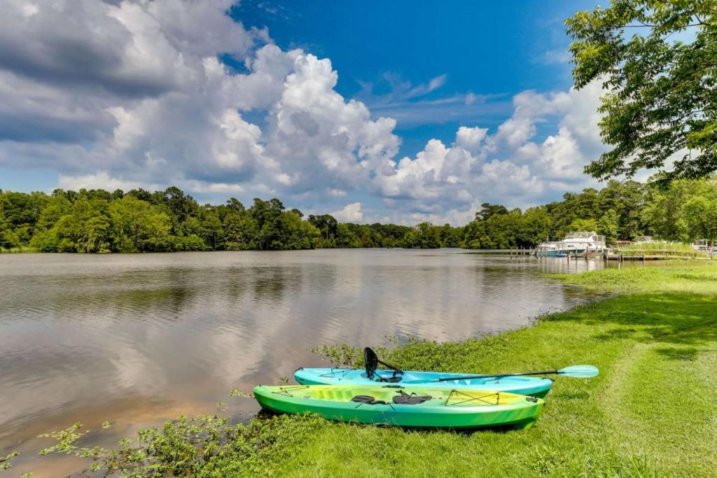 a green boat sitting on the shore of a lake at Bells Marina & Fishing Resort - Santee Lake Marion by I95 - Family Adventure, Pets on Request! in Eutawville