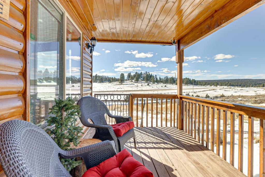 a screened in porch with two chairs and a couch at Cozy Duck Creek Village Cabin with Hot Tub and Views! in Duck Creek Village