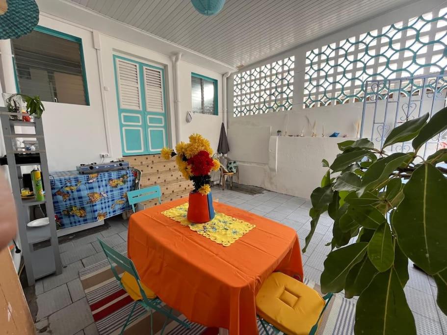 a room with a table with a vase of flowers on it at Case Louis et spa in Saint-Pierre