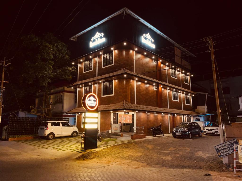 a building with lights on top of it at night at Kovilakam Achutham in Guruvāyūr