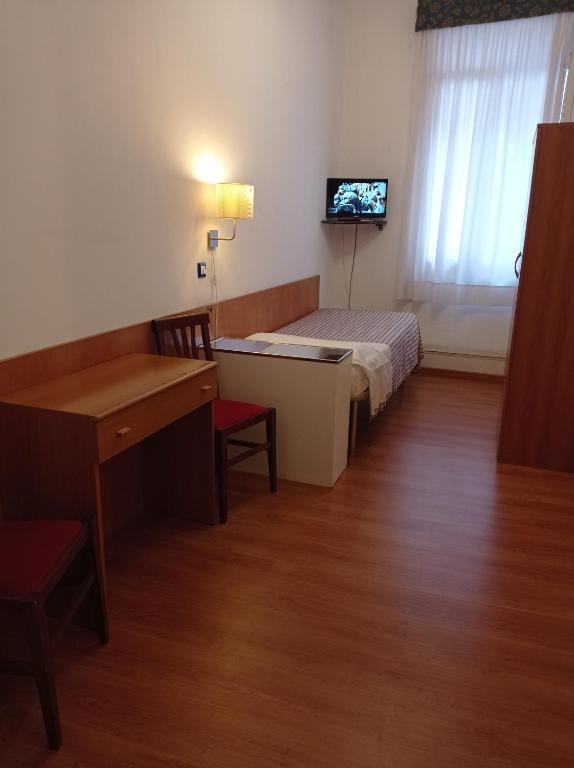 Postel nebo postele na pokoji v ubytování Hotel Caneva