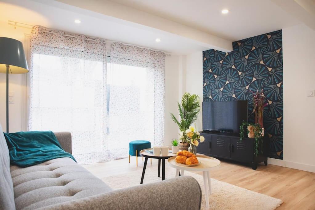 un salon avec un canapé et une table dans l'établissement Le petit Bédier, à Angers