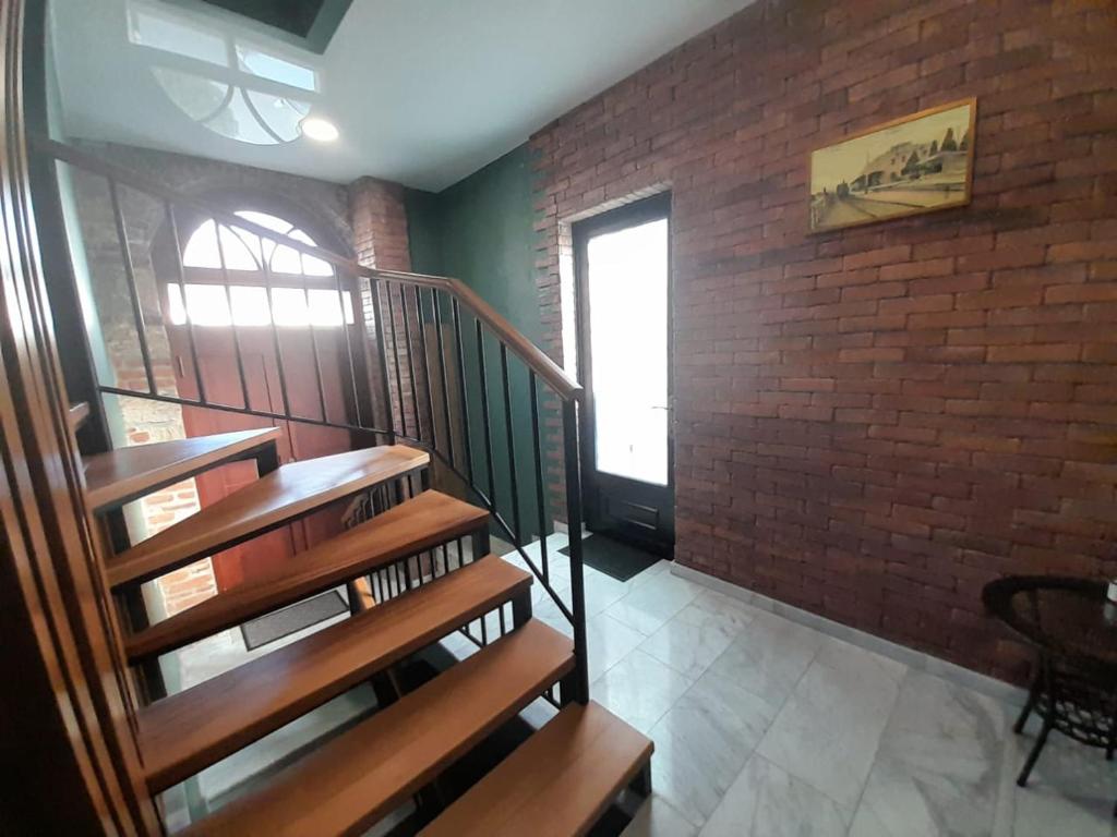 a staircase in a room with a brick wall at Aragvi in Batumi