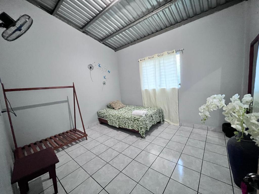 a living room with a bed and a window at Hotel Pacific Surf Best Price At Tunco Beach in El Sunzal