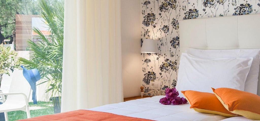 Postel nebo postele na pokoji v ubytování Althea Village - Family Hotel