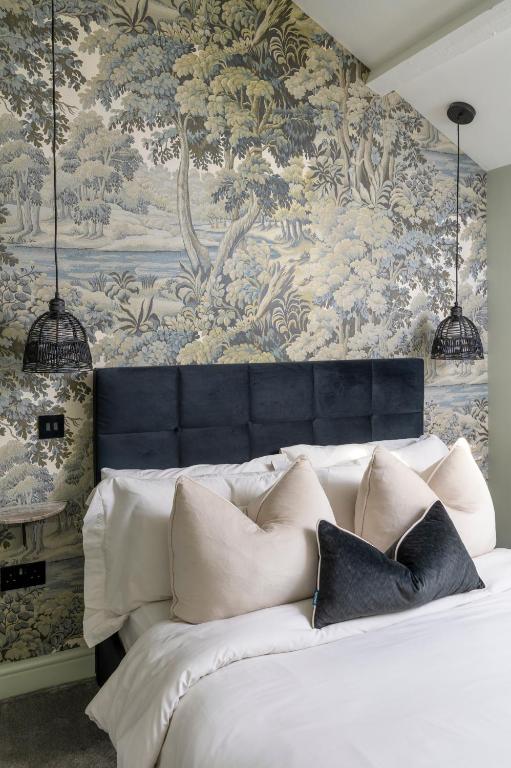 a bedroom with a bed with a wall mural at Gibson Cottage, Penrith, The Lake District in Penrith