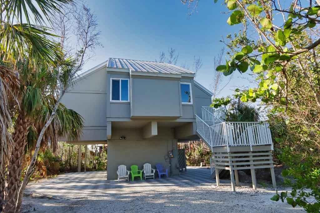 a house with a staircase leading up to it at Sealoft Village #105 - Come stay on Sanibel! in Sanibel