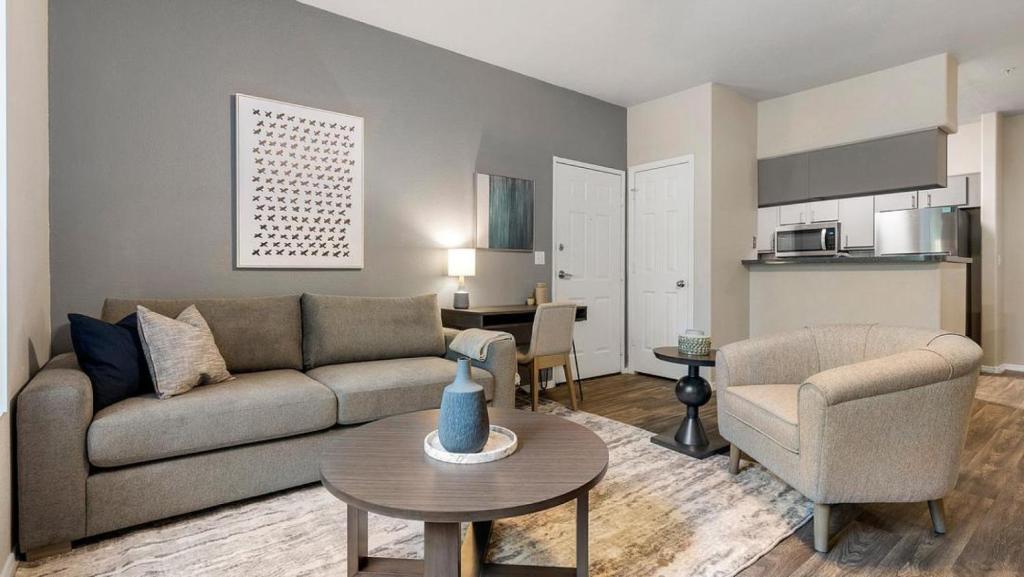 a living room with a couch and a table at Landing - Modern Apartment with Amazing Amenities (ID7762X30) in Leisure World