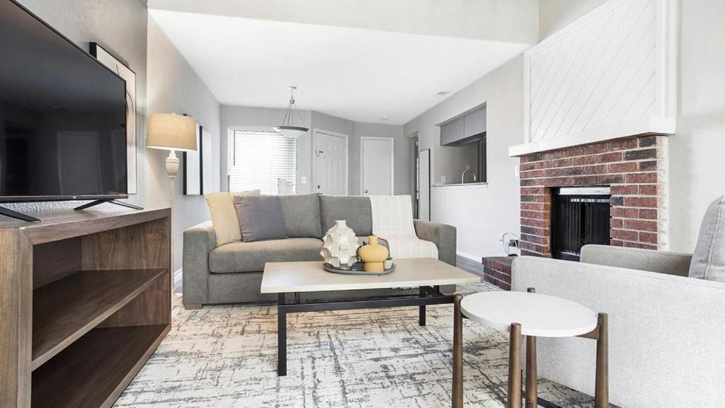 ein Wohnzimmer mit einem Sofa und einem Tisch in der Unterkunft Landing - Modern Apartment with Amazing Amenities (ID7412X03) in Orlando