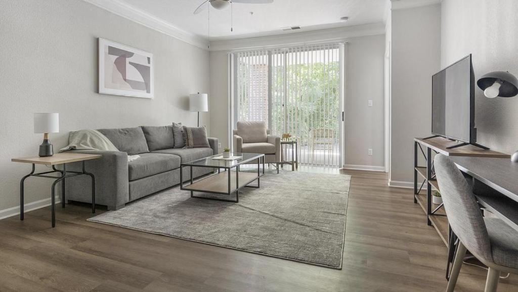 a living room with a couch and a table at Landing - Modern Apartment with Amazing Amenities (ID1374X809) in Charlotte