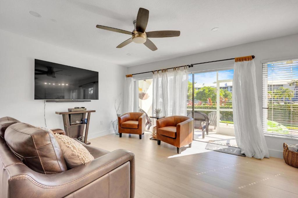 a living room with a couch and a ceiling fan at Overlooking Lagoon and Pool-Free Golf Cart-Kayaks in Key Largo