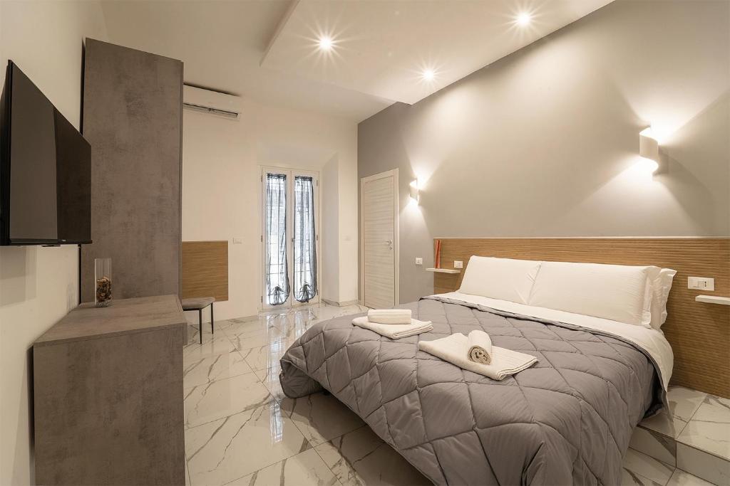 a bedroom with a large bed and a television at TERMINI HOLIDAY in Rome