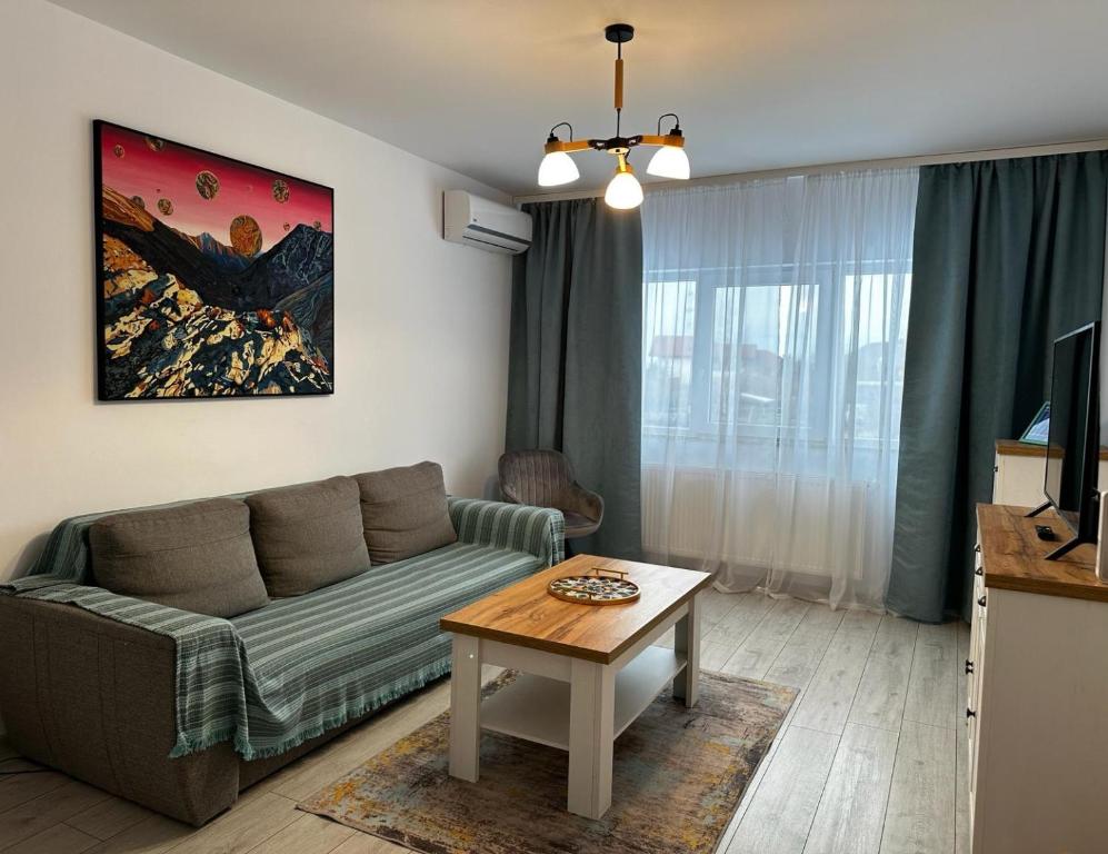 a living room with a couch and a table at Best Apartment Suceava in Suceava