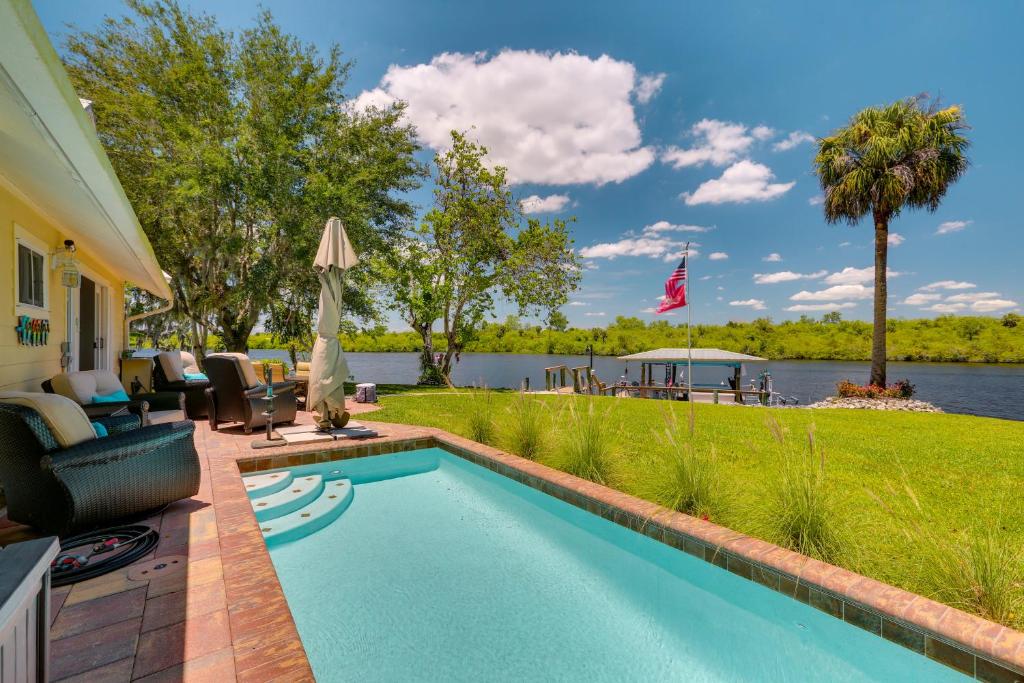 a swimming pool in the backyard of a home at Riverfront Florida Studio with Pool and Hot Tub Access in La Belle