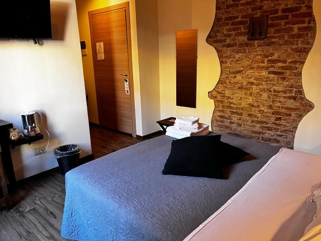 Postel nebo postele na pokoji v ubytování La Taverna del Metallo Rooms