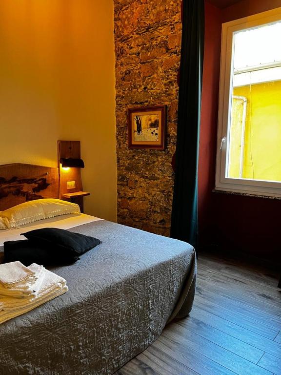 Postel nebo postele na pokoji v ubytování La Taverna del Metallo Rooms
