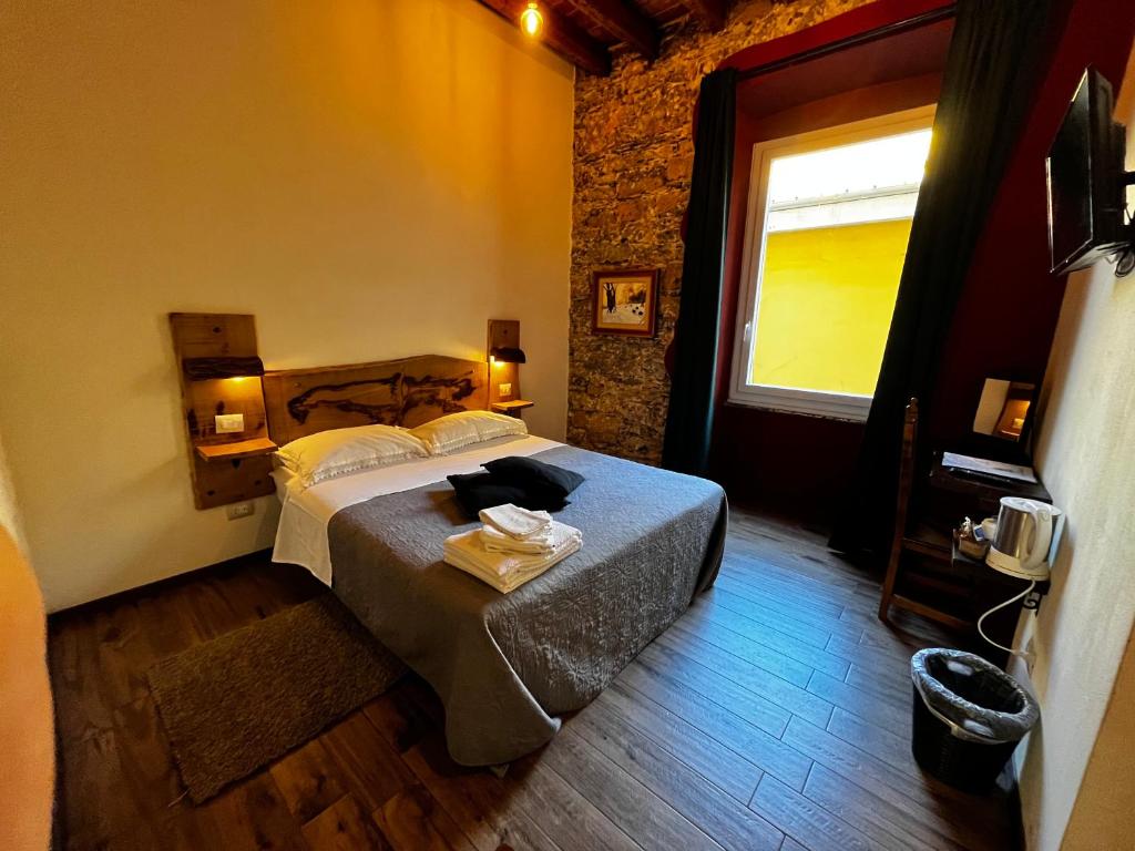 Postel nebo postele na pokoji v ubytování La Taverna del Metallo Rooms