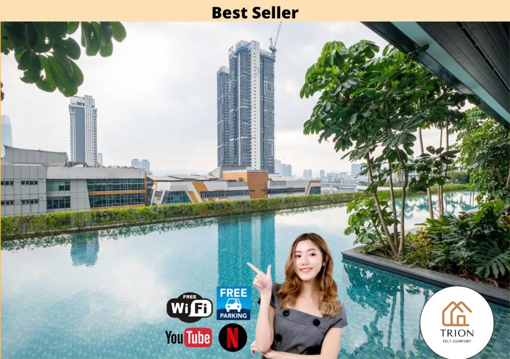 a woman standing in front of a swimming pool with a city at Trion Kuala Lumpur Near Sunway Velocity KLCC TRX Bukit Bintang in Kuala Lumpur