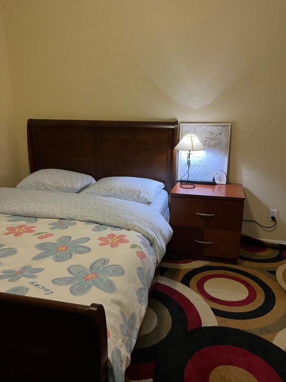 a bedroom with a bed and a table with a lamp at Comfortable room in Riverside in Riverside