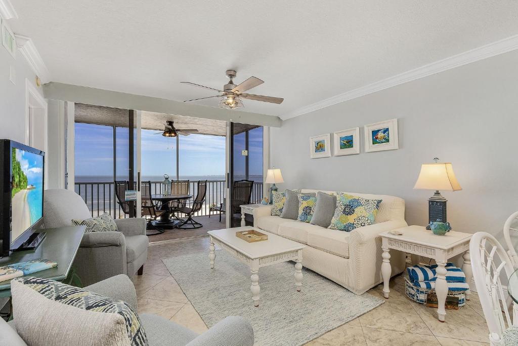 a living room with a couch and a table at Beach Villas # 304 - BOGO24 condo in Fort Myers Beach