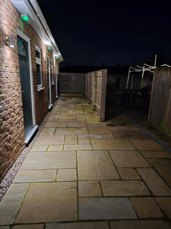 an empty alley with a brick building at night at The Woodmans Cottage in Gorfield