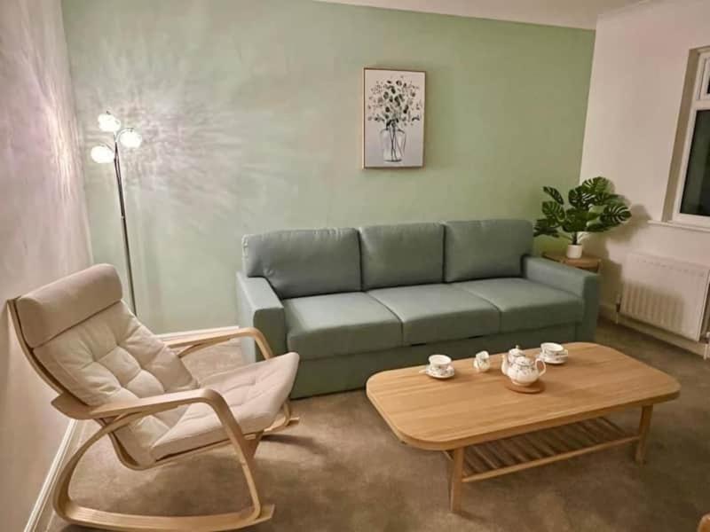a living room with a couch and a coffee table at Betty's Bungalow in Lancing