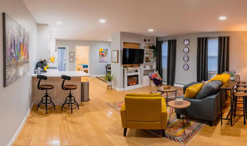 a living room with a couch and a kitchen at New Beautiful Condo In Bayonne near NYC. in Bayonne