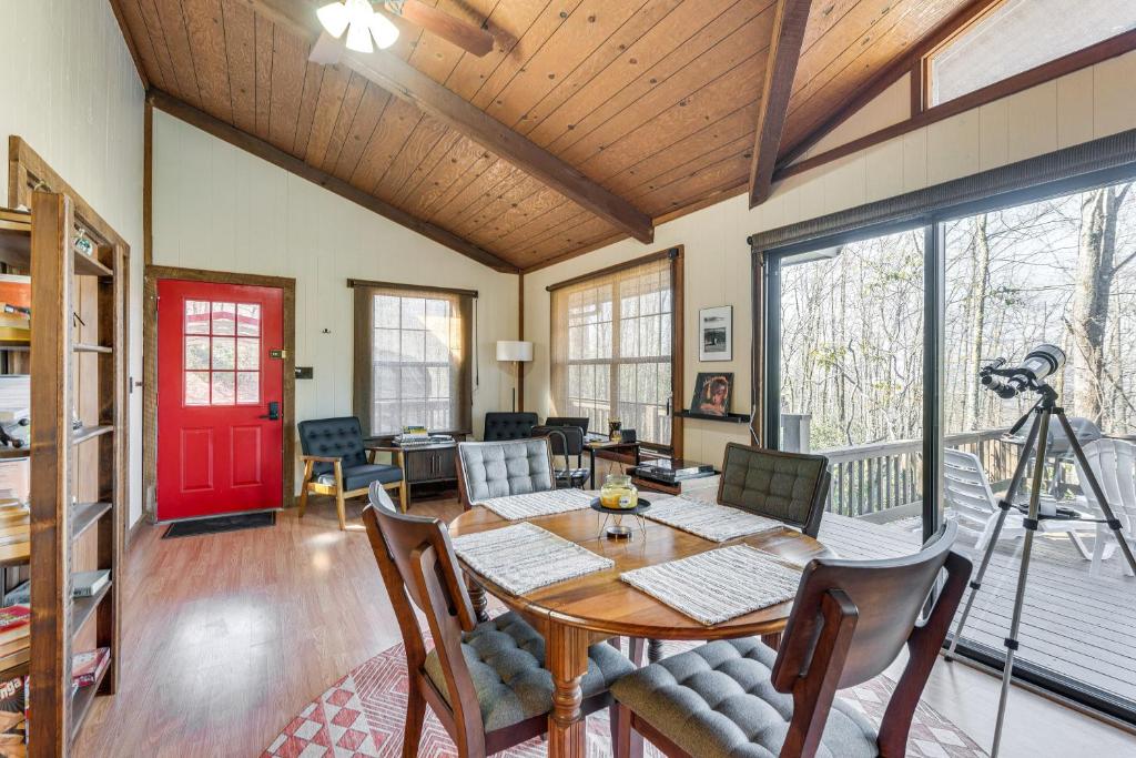 a dining room with a table and a red door at Smoky Mountain Cabin with Fire Pit and Stunning Views! in Andrews