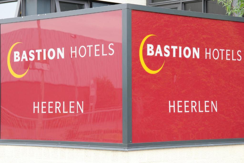 a sign for aisson hotels on a building at Bastion Hotel Heerlen in Heerlen