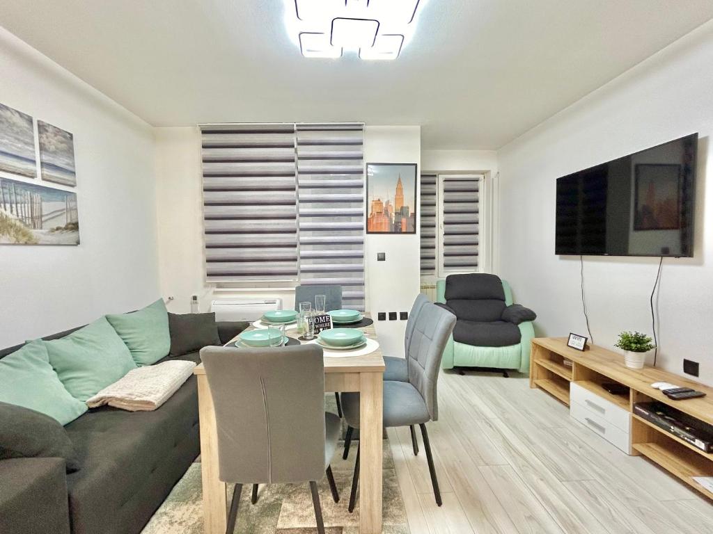 a living room with a couch and a table at Best Family Apartment in Varna City