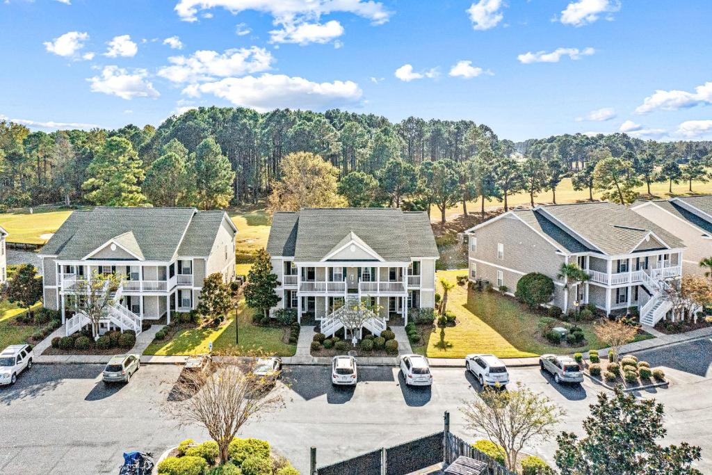 an aerial view of a large house with a parking lot at Sunset Paradise in Sunset Beach