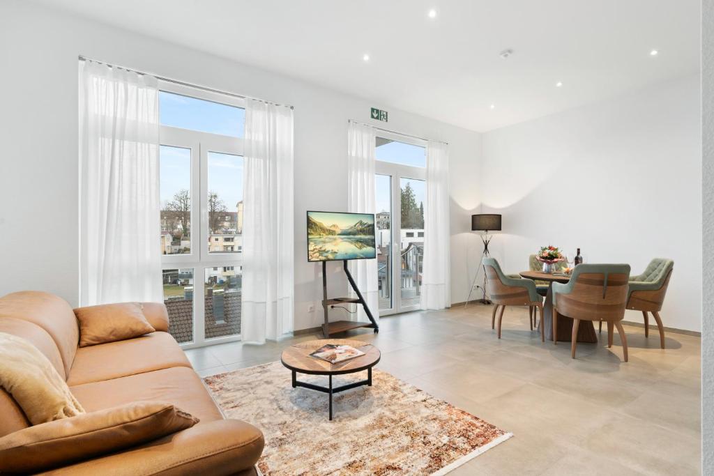 a living room with a couch and a table at Premium SmartApart mit Smarthome zentral modern 24h-check-in in Tettnang