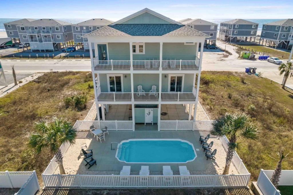 an aerial view of a house with a swimming pool at Beers and Sunshine Ocean Isle Beach, Heated pool, elevator, across from beach access in Ocean Isle Beach